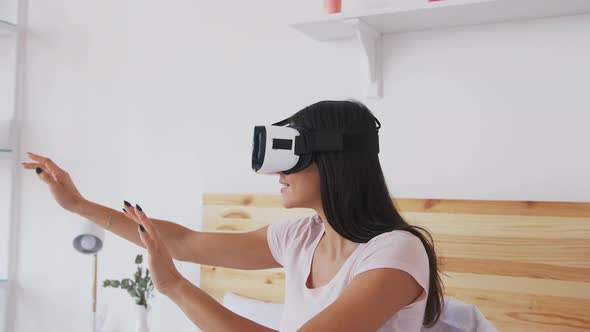 Portrait of Smiling Happy Young Woman Getting Experience Using VR Glasses at Home