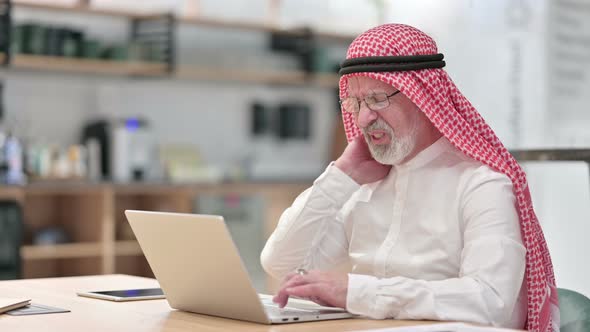 Senior Old Arab Businessman with Laptop Having Neck Pain