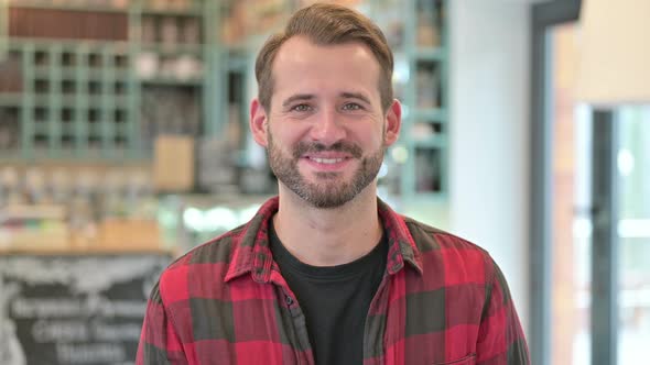 Portrait of Cheerful Young Man Smiling at Camera 