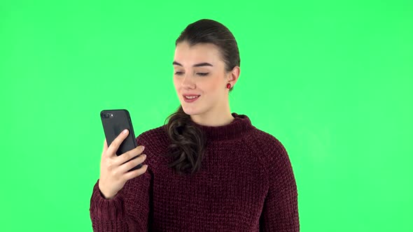 Girl Angrily Talking for Video Chat Using Mobile Phone on Green Screen