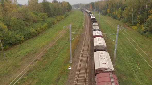 Flying Over a Freight Train Moving in the Countryside