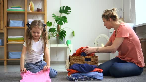 Mom and Child Fold Clothes Together