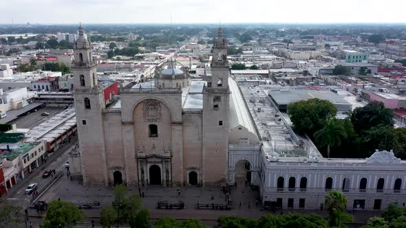 Aerial camera backing slowly away from the Cathedral of Merida at the Grand Plaza in Merida, Yucatan