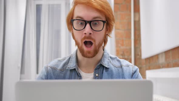 Man Working on Laptop and Reacting to Success