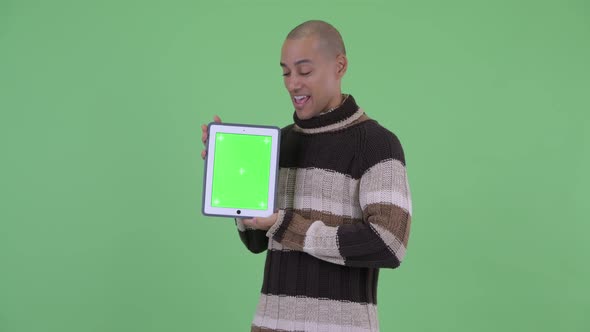 Happy Bald Multi Ethnic Man Talking While Showing Digital Tablet