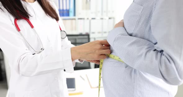 Doctor Obstetriciangynecologist Measuring Volume of Abdomen of Pregnant Woman Using Centimeter Tape