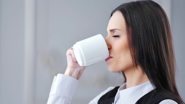 Closeup Pensive Elegant Businesswoman Enjoying Drinking Hot Beverage From White Mug