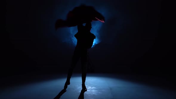 Torero in Blue and Gold Suit or Typical Spanish Bullfighter Silhouette on a Blue Background of Smoke