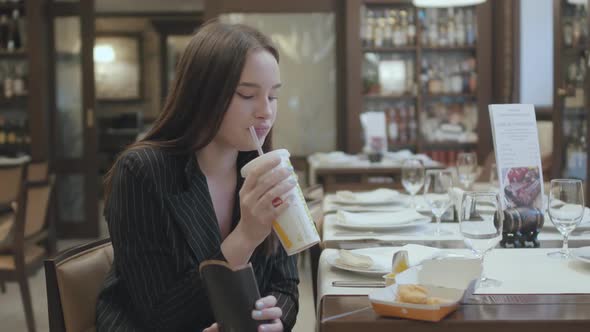 Portrait Cute Woman in the Suit Sitting in the Restaurant Eating Fast Food. Attractive Brunette Lady