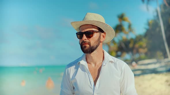 Tourist Walking On Tropical Beach.Elegant Man On Zanzibar Nungwi.Tanned Man In Hat.