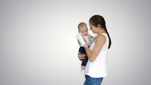 Young mother holding her baby in hands and walking, Alpha Channel