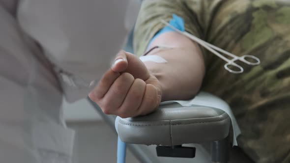 Blood Donor at Donation at Medical Centre. Close Up Footage Arm of Man Receiving Blood in Hospital