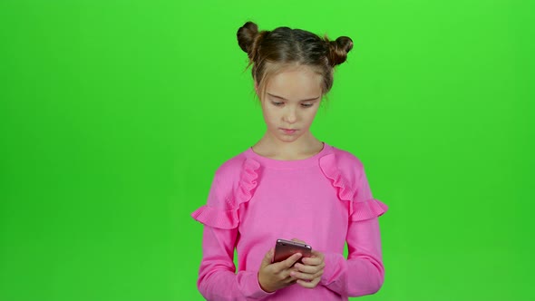 Child Is Talking on the Phone with Her Mom. Green Screen. Slow Motion