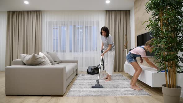 Preteen Daughter and Mother Cleaning Their Home's Living Room Slow Motion