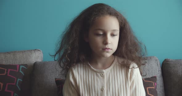 Portrait of a Sad Little Girl an Upset Child Lowering Her Eyes to the Floor and Then Looking at