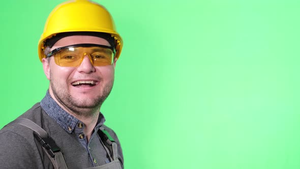 Portrait of Engineer Worker Man on Green Background Laughing Showing Thumb Up