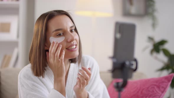 Woman Applying Eye Patches