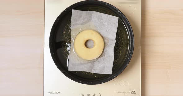 4K - Cooking deep-fried donut. Top view