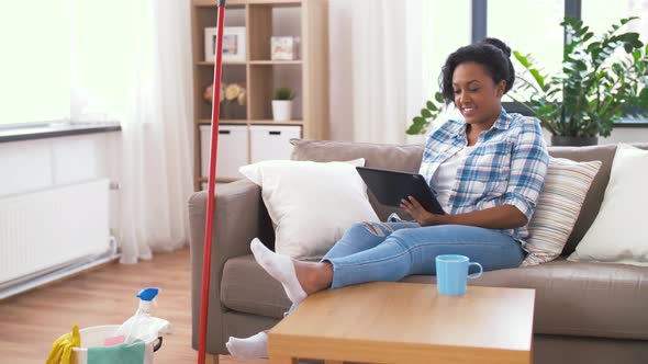 Woman with Tablet Pc Resting After Home Cleaning 25