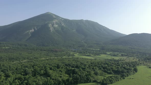 Ascending over the valley under Rtanj mountain 4K video