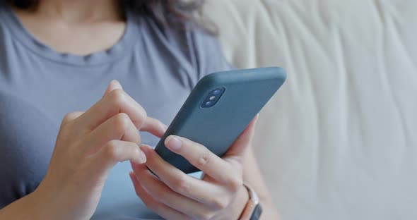 Close up of woman use mobile phone at home