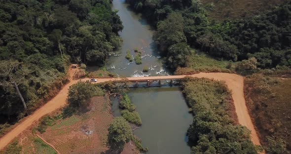 Aerial view of an off-road vehicle crossing a bridge in Angola, Africa