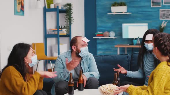 Happy Persons with Sticky Notes on Forehead Playing Name Game