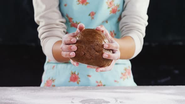 Woman molding a dough