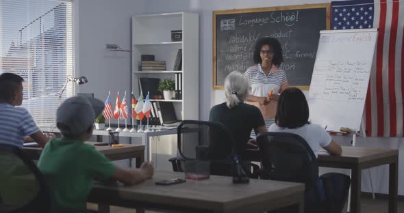 Teacher Using Flip Chart While Explaining To a Class