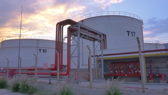 Oil Storage Tanks at Sunset Time