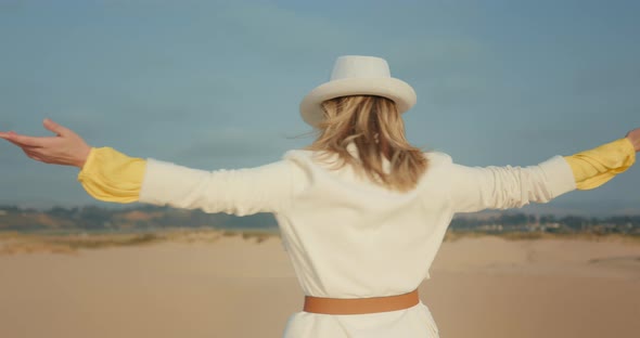 Happy Woman Turning Around Desert Landscape in Slow Motion