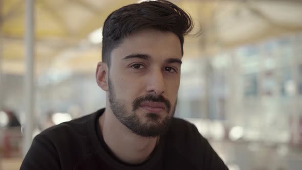 Happy Young Man Looking at Camera in Cafe