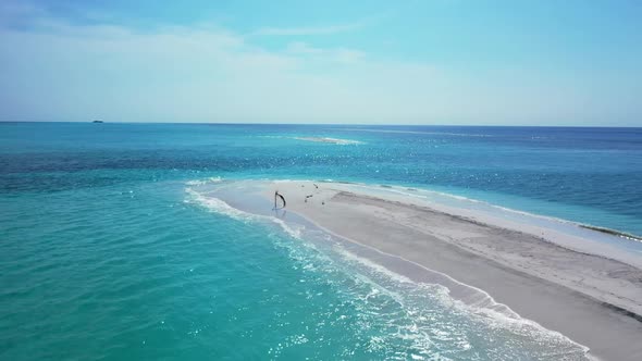 Aerial drone shot panorama of beautiful lagoon beach adventure by aqua blue sea with bright sand bac