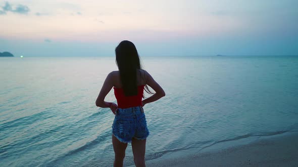 Cute Smiling Asian Girl Walking on a Beach at Sunset in Slow Motion Thailand