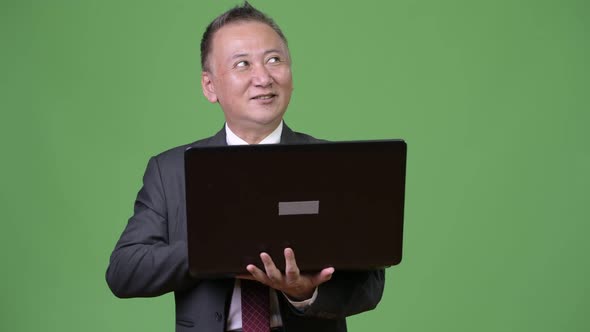 Mature Japanese Businessman Working with Laptop