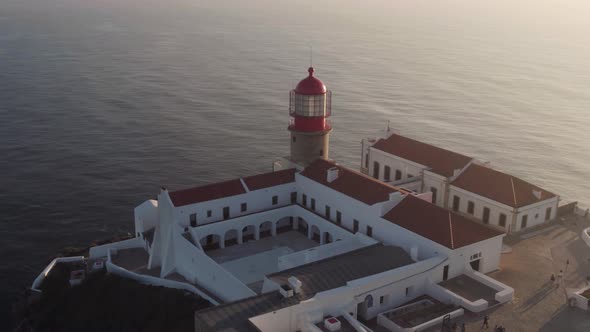 Cabo de Sao Vicente beacon and courtyard of the convent, Sagres, Algarve. Aerial sunset view