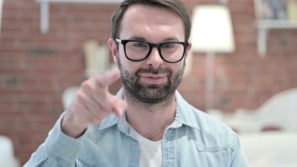 Portrait of Beard Young Man Pointing Finger and Inviting 