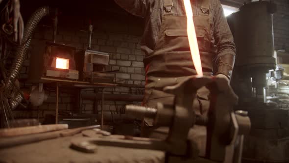 A Man Blacksmith Forging a Knife - Putting the Sample Between the Clamps