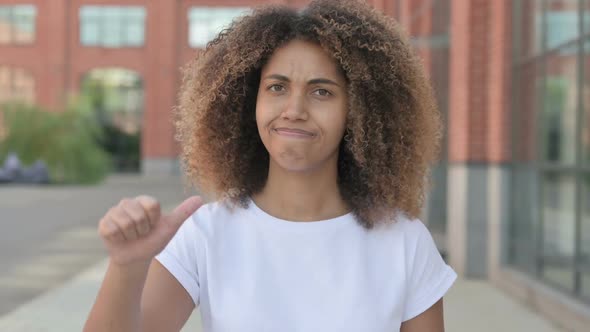 African Woman Showing Thumbs Down Gesture Outdoor