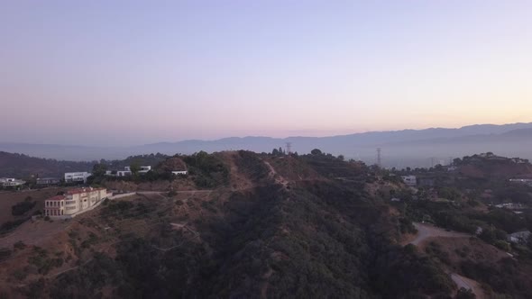 AERIAL Over Hollywood Hills at Sunrise with View on Hills and the Valley in Los Angeles View