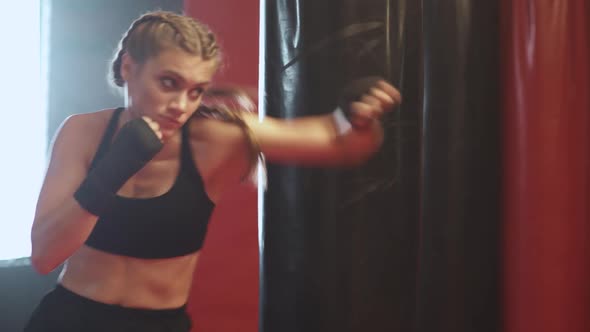 Woman Fighter Trains His Punches Training in the Boxing Gym the Girl Trains a Series of Punches Fast