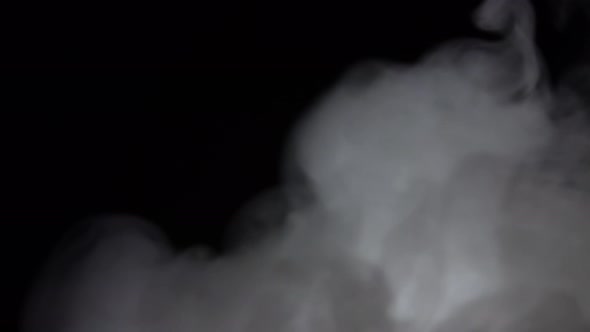 White Smoke Floating Through Space Against Black Background. Mist, Smoke , Vapor, Fog Effect.