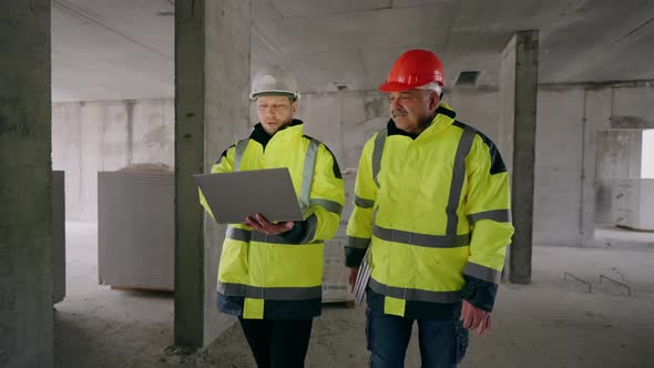 Civil Engineer and Foreman are Viewing and Examining Underconstruction Building