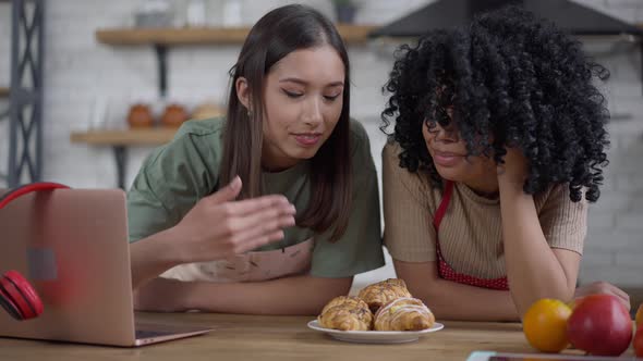 Two Smiling Slim Beautiful Women Talking Smelling Homemade Croissants