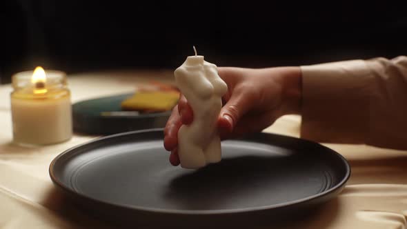 Closeup of Talented Female Artisan Putting on Table Ready to Use Handmade Candle in Shape of Torso