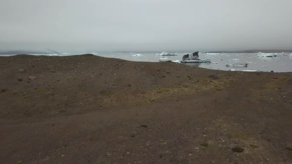 Aerial dolly in revealing ice bocks floating in Jökulsárlón glacial lake near Breiðamerkurjökull gla