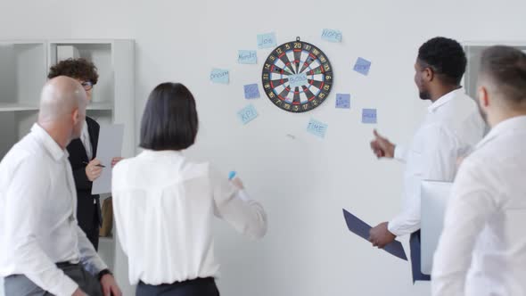 Woman Throwing Darts at Motivational Words