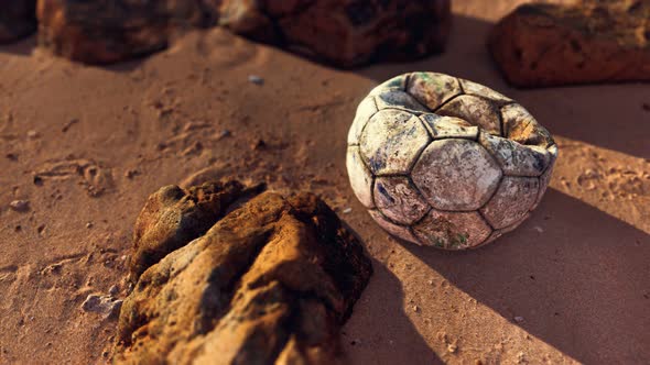 Old Leather Soccer Ball Abandoned on Sand