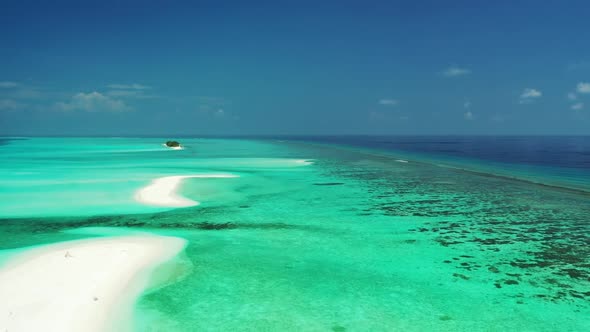 Aerial drone shot travel of marine coastline beach break by aqua blue sea with white sandy backgroun