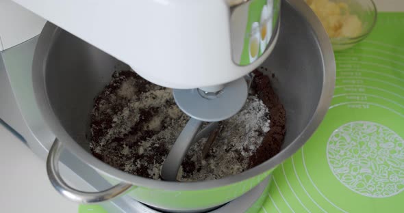 Mixer Whips Chocolate Cream for Cake. Professional Baker Preparing the Cake Batter, Making Cream